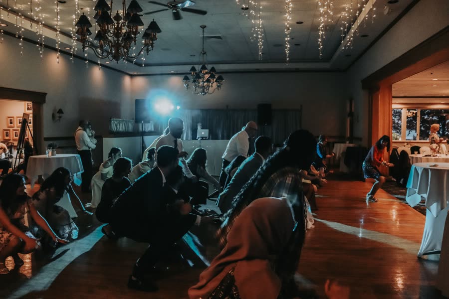 Guests crowding the dance floor under a spotlight